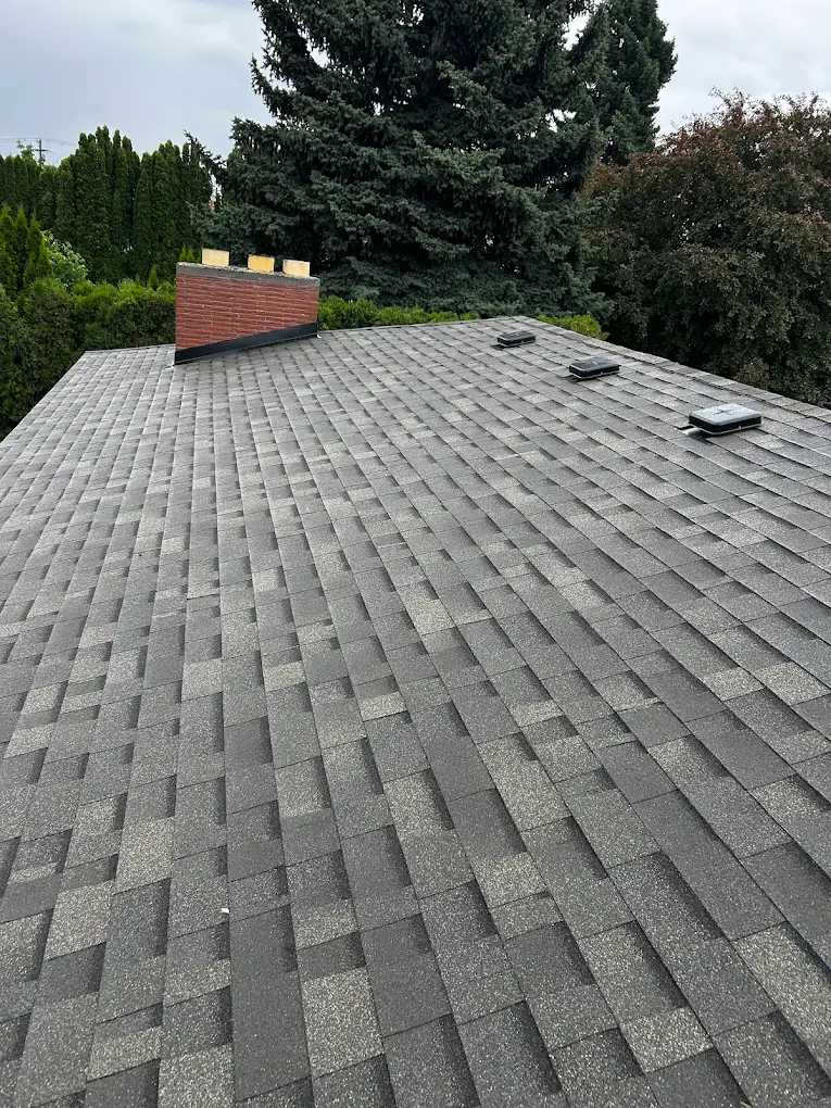 Worn asphalt shingle roof before replacement in Spokane